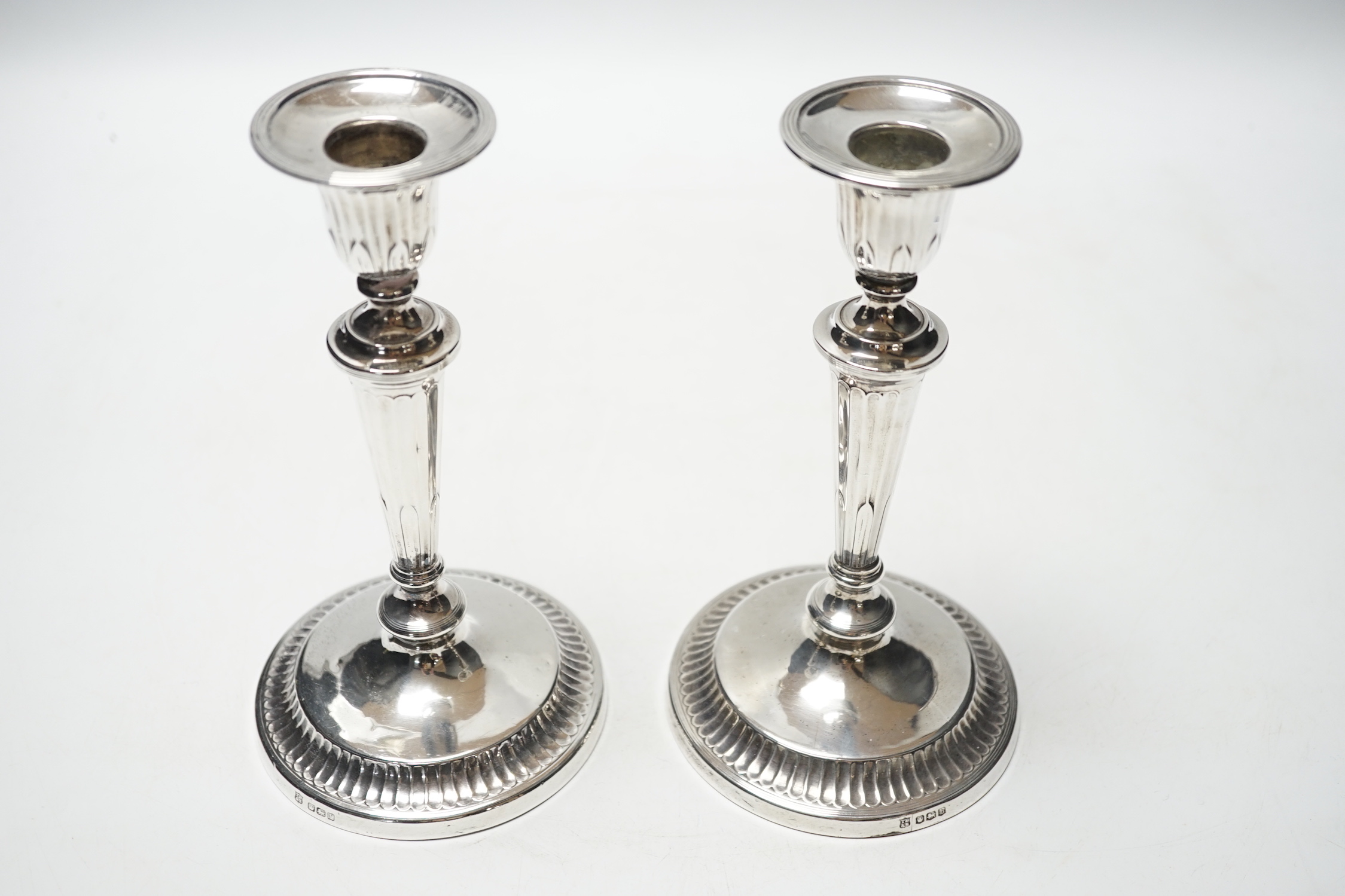 A pair of George V silver mounted candlesticks, Thomas Bradbury & Sons, Sheffield, 1919, 18.6cm, weighted.